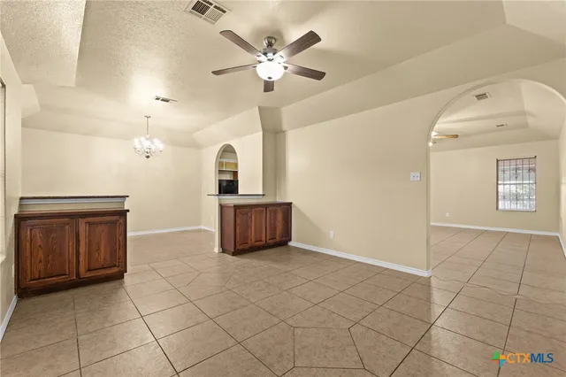 a view of an empty room with a kitchen