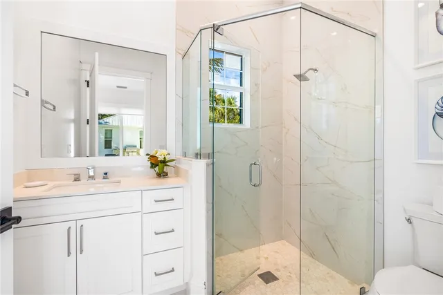 a bathroom with a double vanity sink mirror and shower