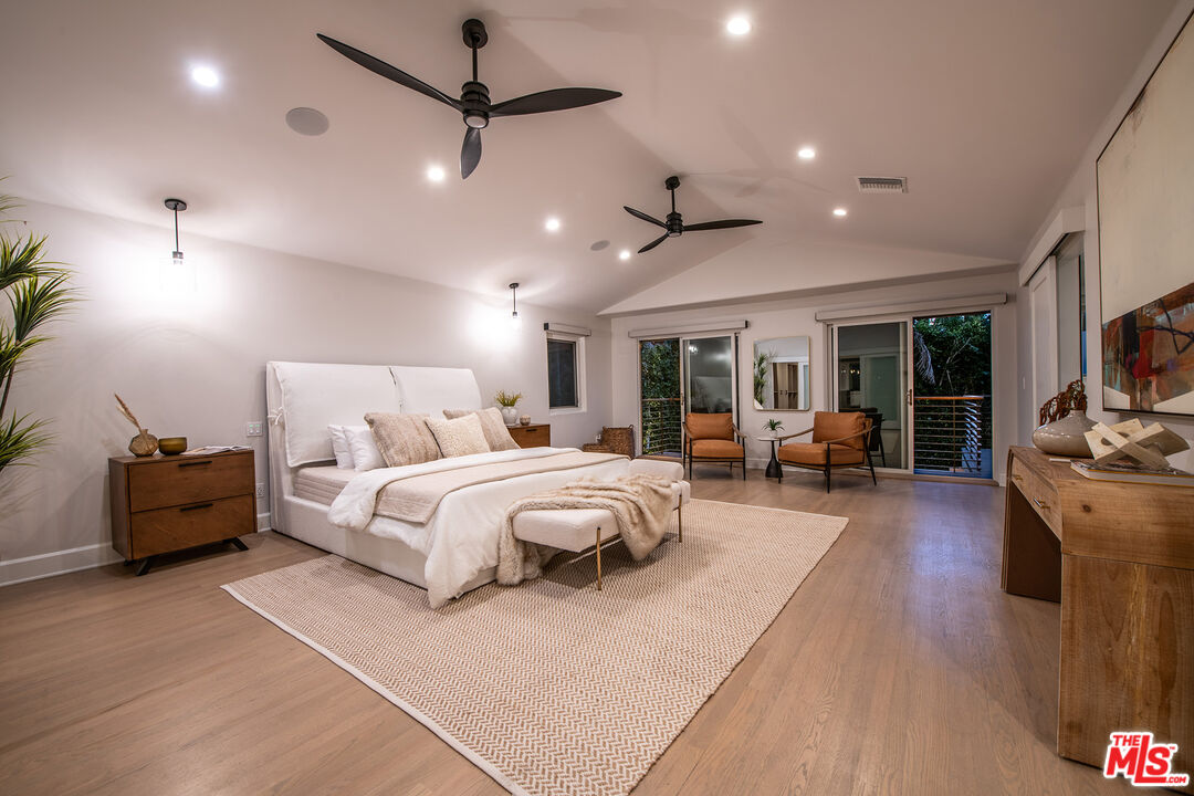 3201 Viola Place Marina del Rey, CA 90292 - Photo 69 of 72 a spacious bedroom with a bed a couch and a chandelier