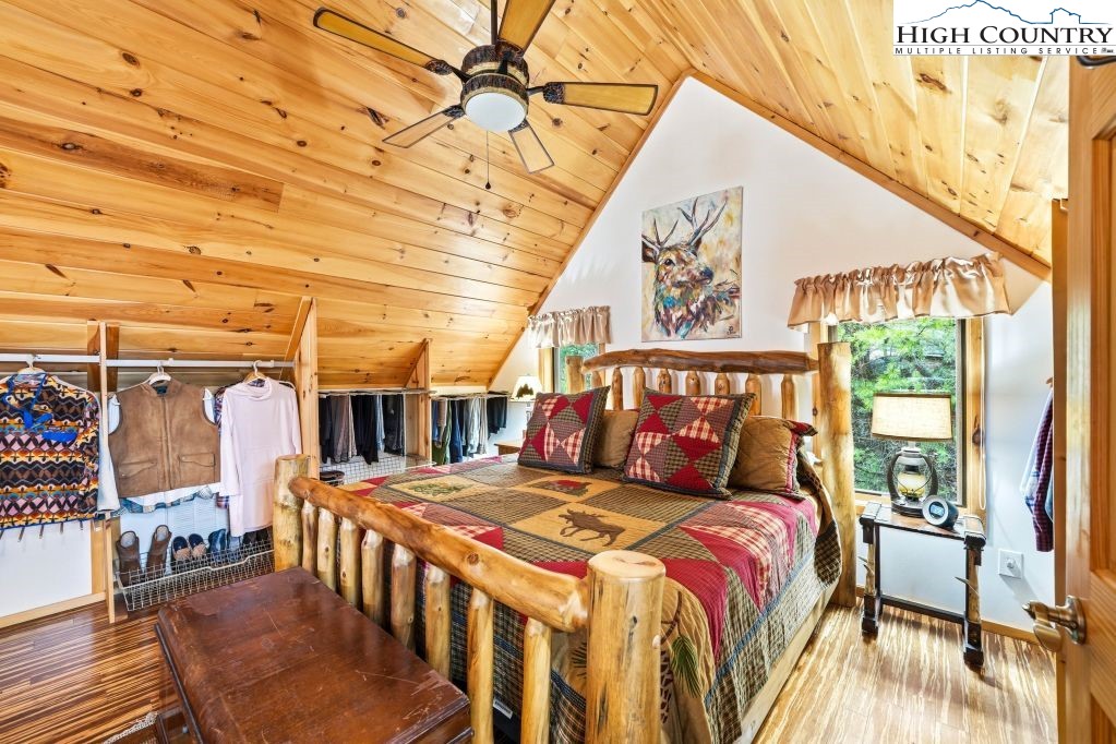 408 Eagle Ridge Road Roan Mountain, TN 37687 - Photo 17 of 45 a bedroom with a large bed and a window