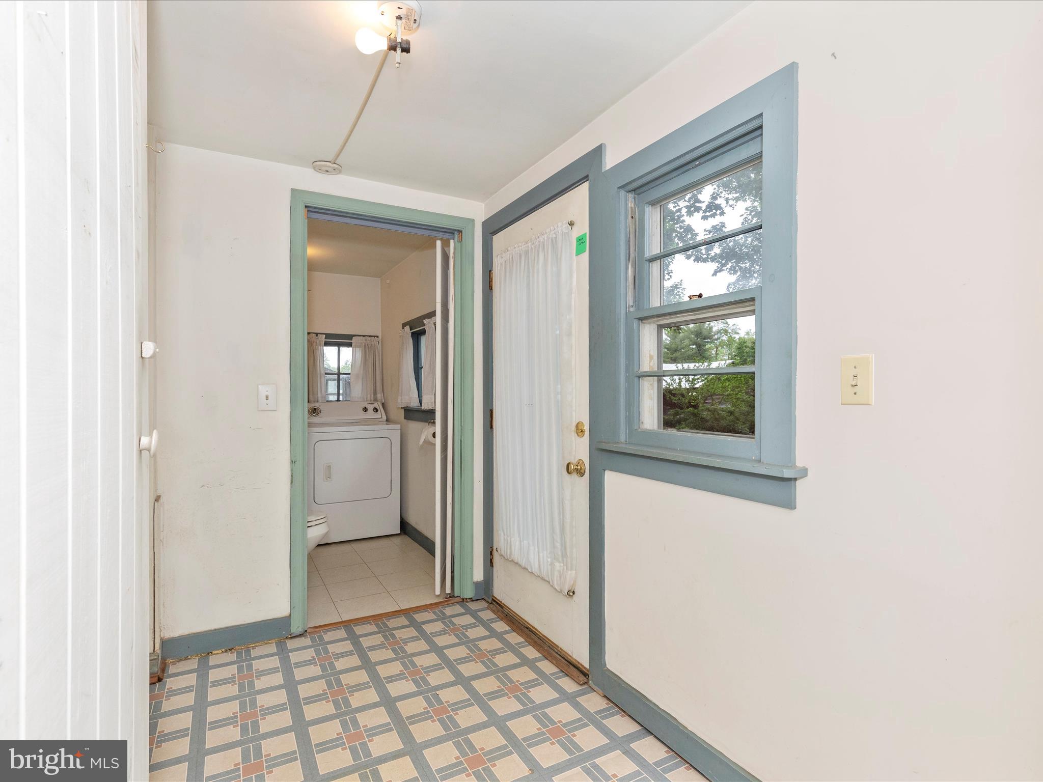3204 Uniontown Road Westminster, MD 21158 - Photo 14 of 51 a view of a hallway with a dining room and chandelier