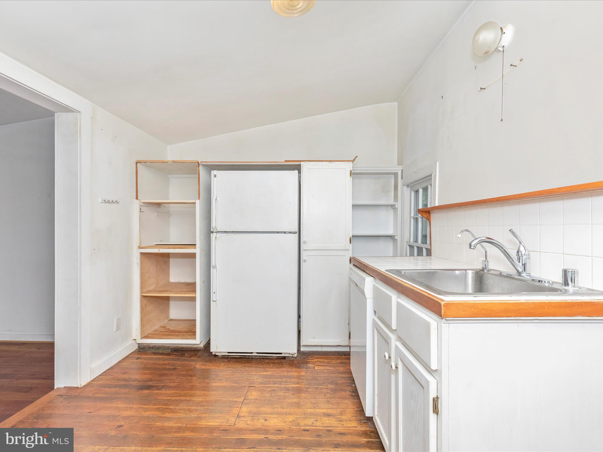 3204 Uniontown Road Westminster, MD 21158 - Photo 16 of 51 a kitchen with a sink a refrigerator and a sink