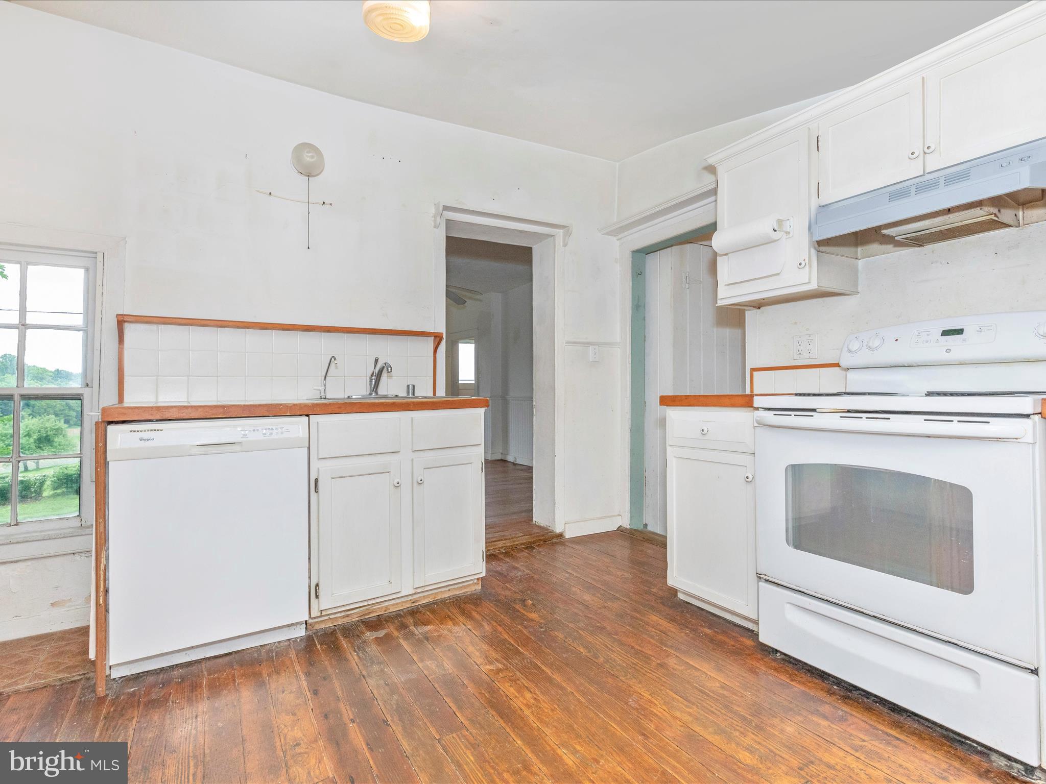 3204 Uniontown Road Westminster, MD 21158 - Photo 18 of 51 a kitchen with white cabinets and white appliances