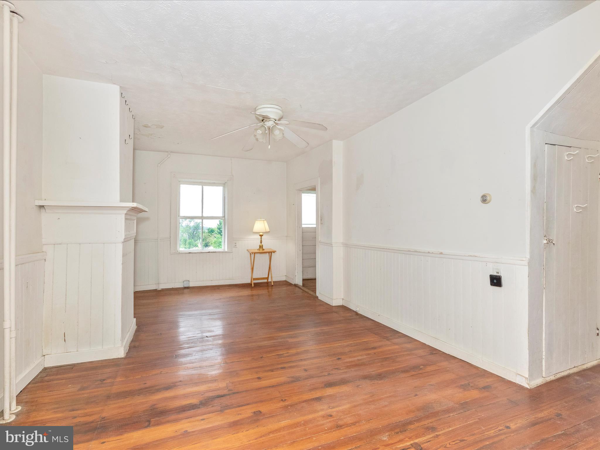 3204 Uniontown Road Westminster, MD 21158 - Photo 27 of 51 a view of an empty room with window and wooden floor