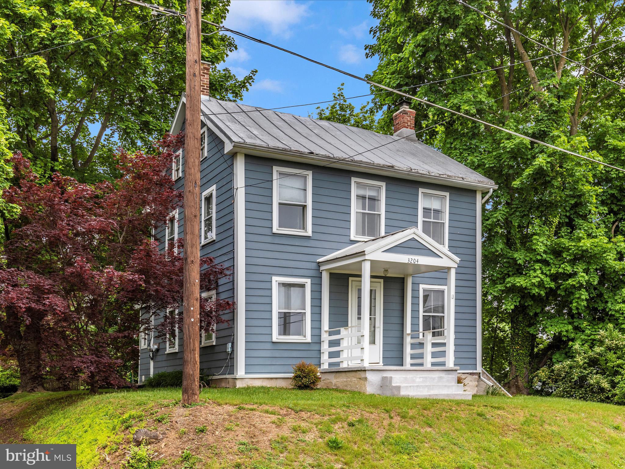 3204 Uniontown Road Westminster, MD 21158 - Photo 3 of 51 a front view of a house with a garden