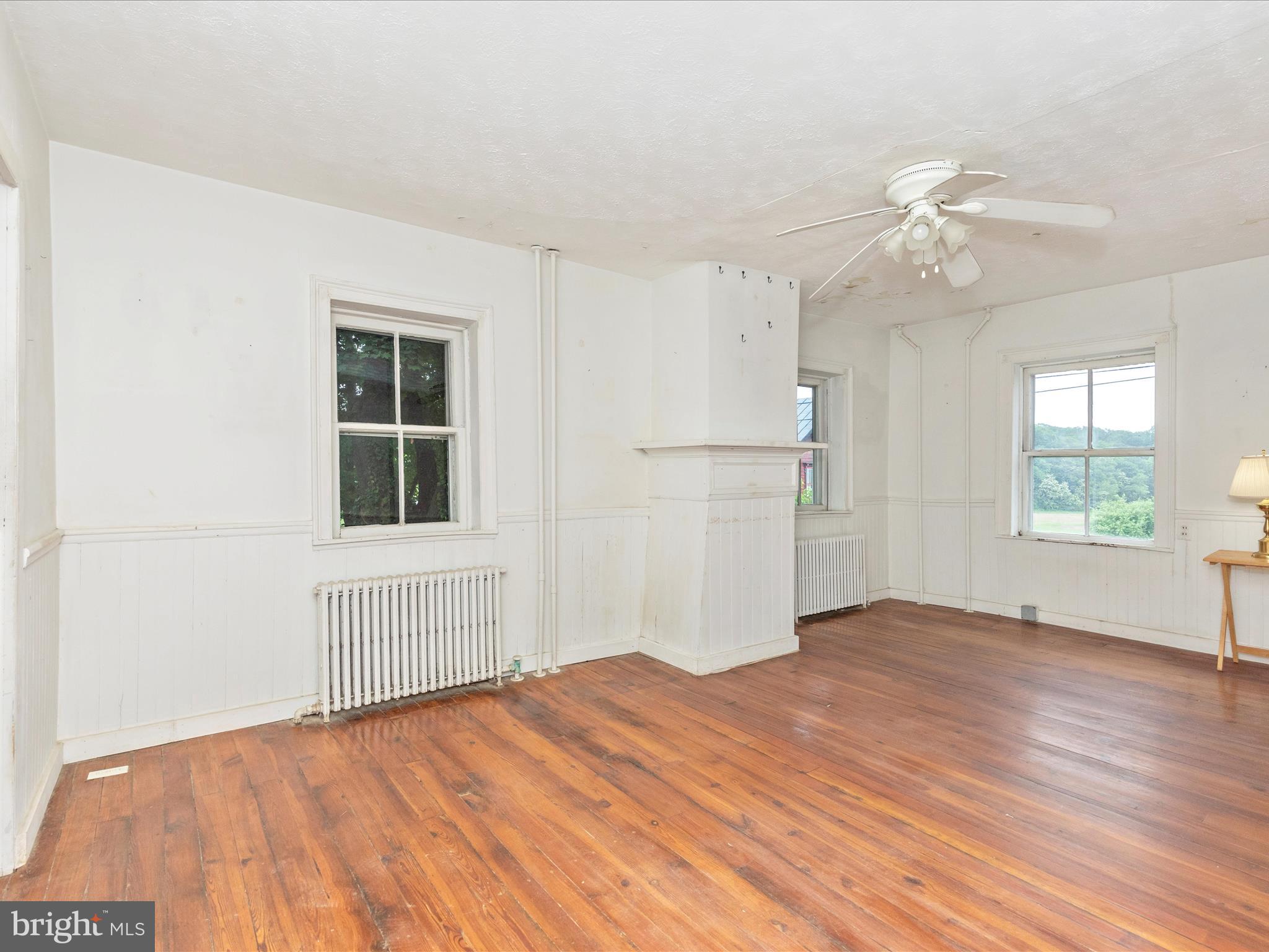 3204 Uniontown Road Westminster, MD 21158 - Photo 31 of 51 a view of empty room with wooden floor and fan