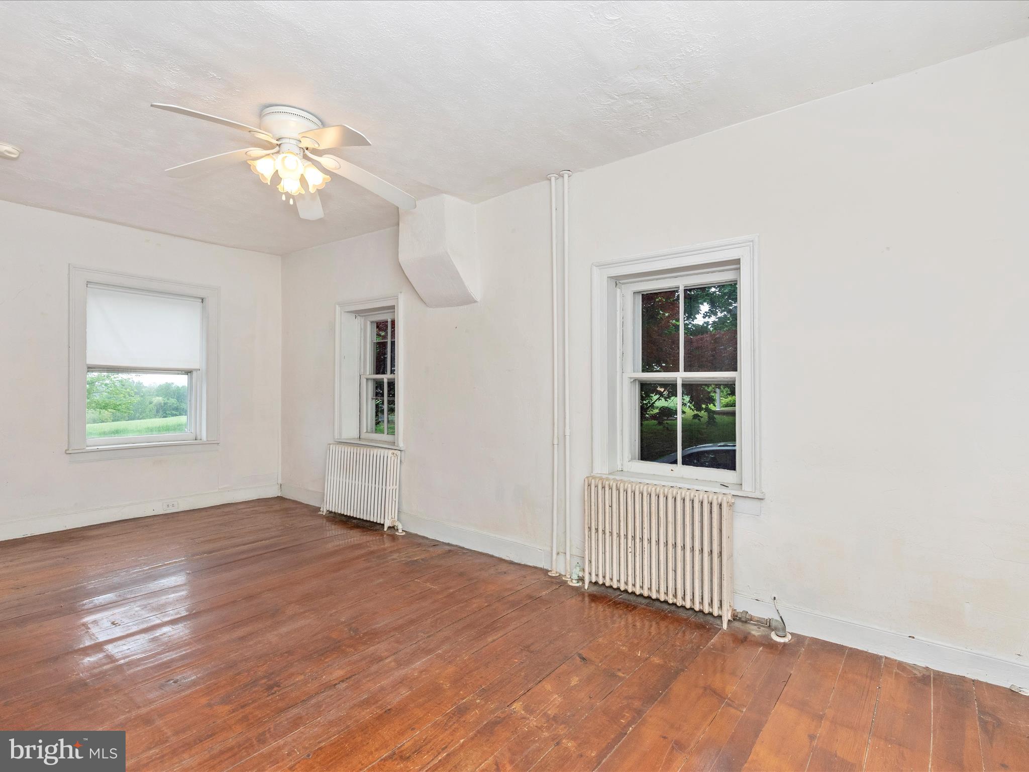3204 Uniontown Road Westminster, MD 21158 - Photo 32 of 51 a view of an empty room with wooden floor and a window