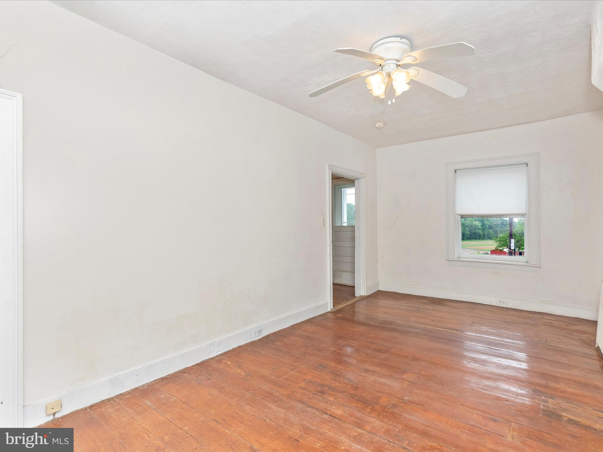 3204 Uniontown Road Westminster, MD 21158 - Photo 33 of 51 wooden floor in an empty room with a window