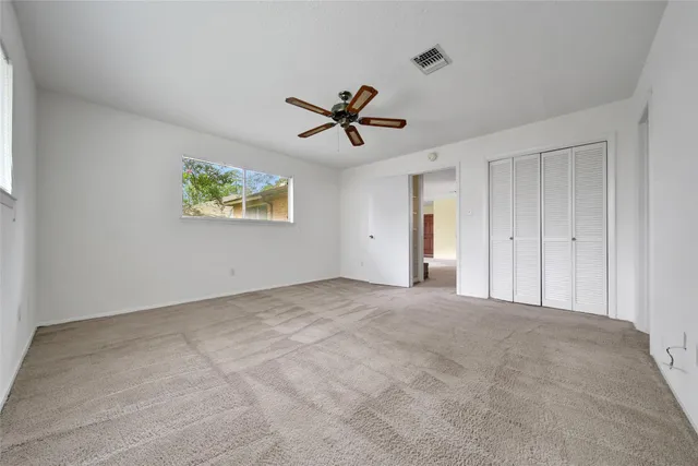 a bathroom with a granite countertop toilet a sink and a mirror