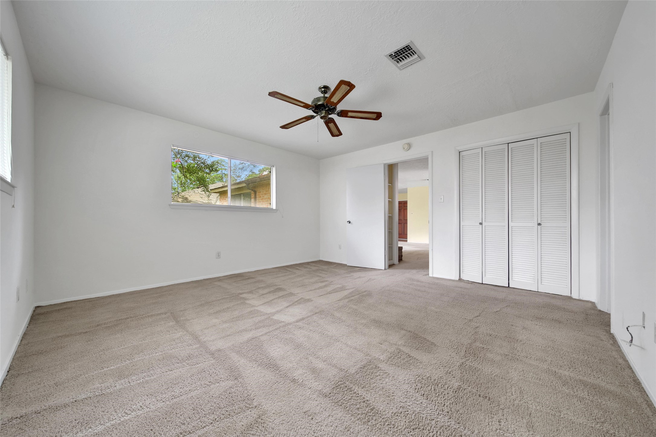 1712 Lindy Lane Conroe, TX 77301 - Photo 13 of 20 a view of a livingroom with a ceiling fan and window