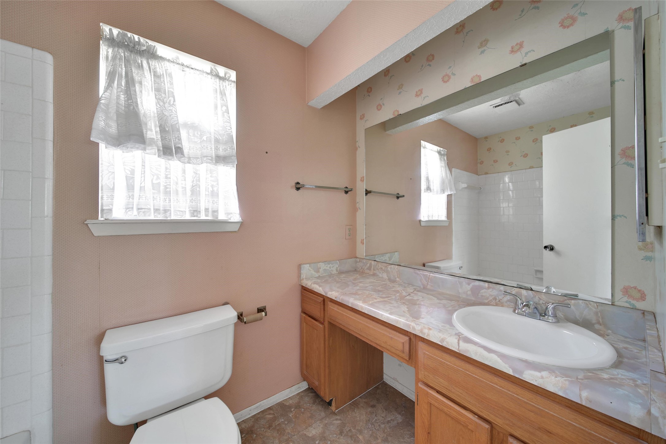 1712 Lindy Lane Conroe, TX 77301 - Photo 14 of 20 a bathroom with a granite countertop toilet a sink and a mirror