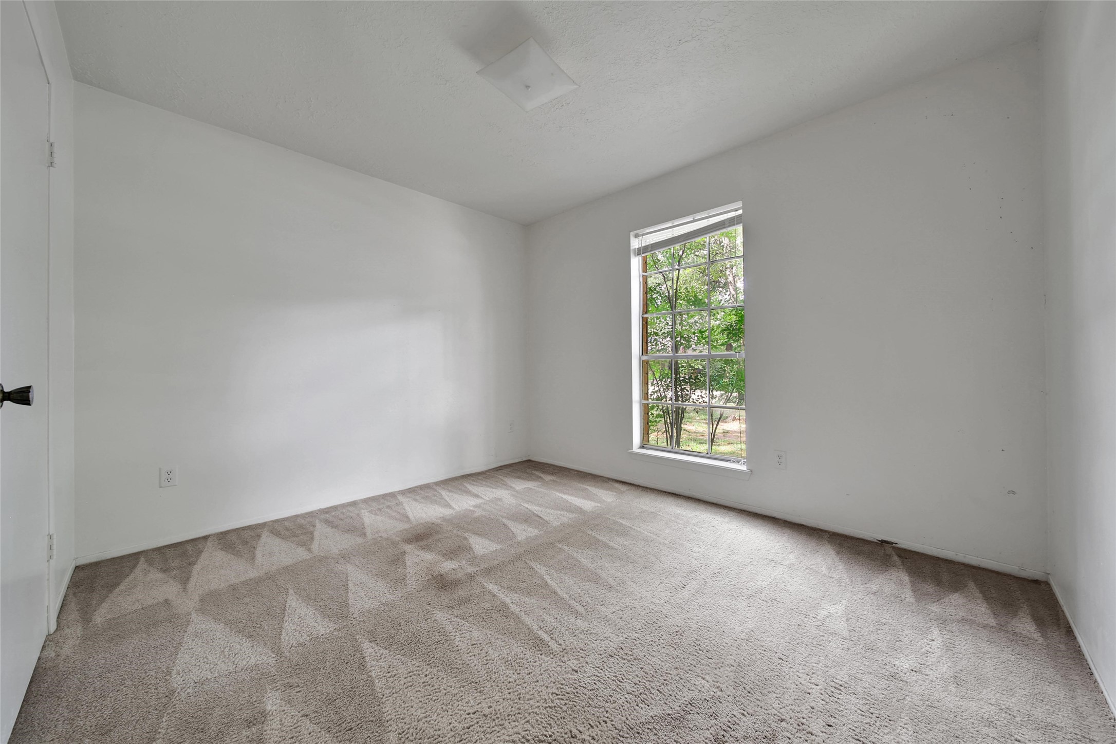 1712 Lindy Lane Conroe, TX 77301 - Photo 15 of 20 a view of an empty room with a window