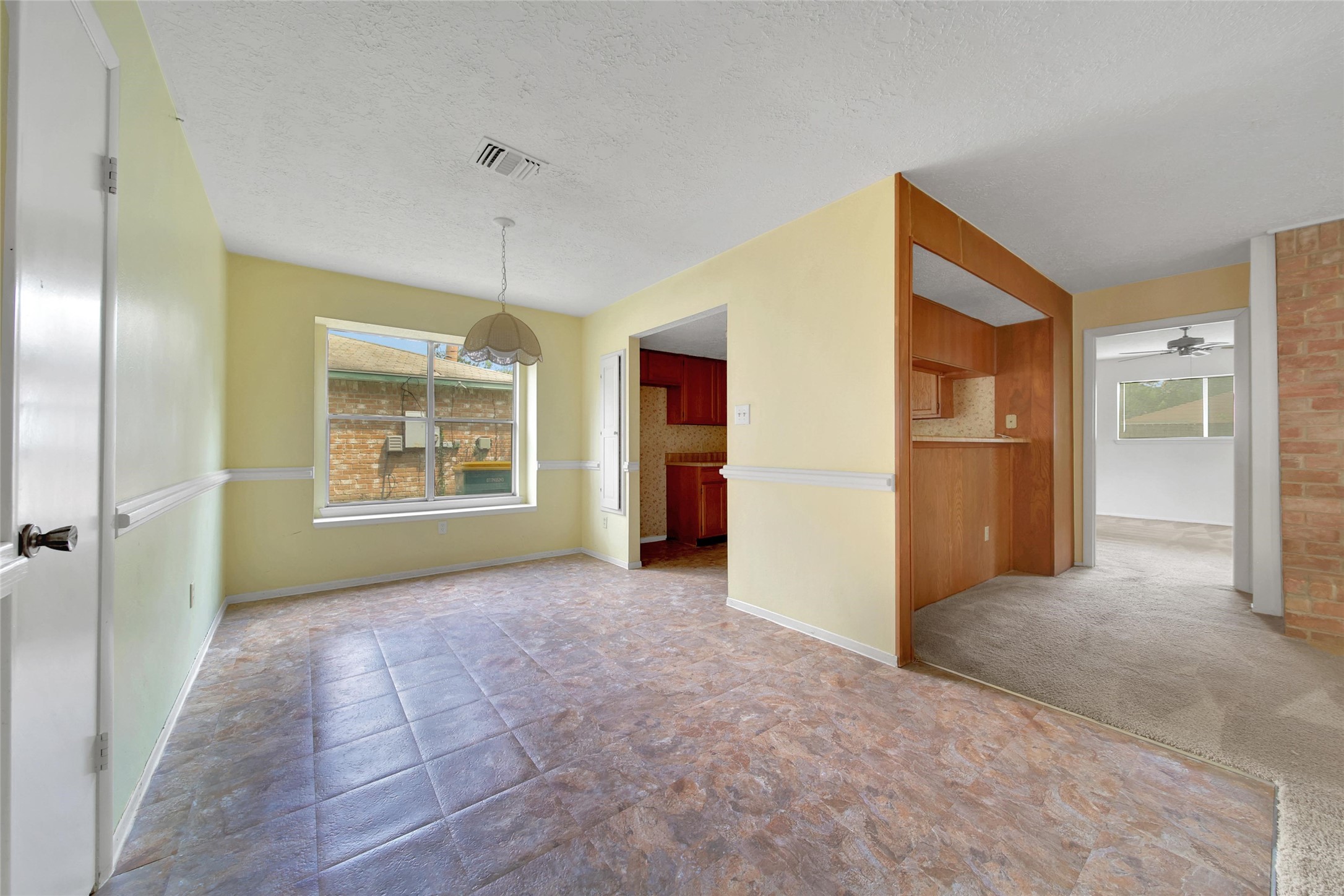 1712 Lindy Lane Conroe, TX 77301 - Photo 8 of 20 an empty room with kitchen and windows