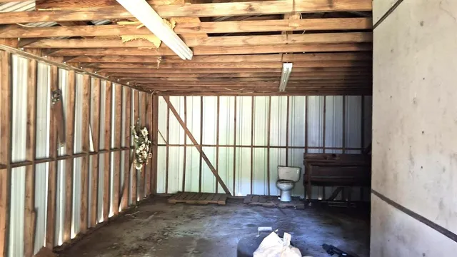 a view of a porch with a table and chairs