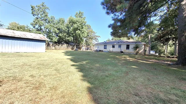 a view of swimming pool with trees in the background
