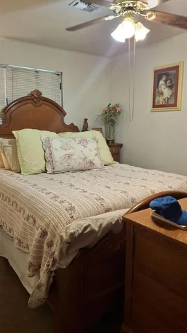 a bedroom with a bed and a lamp