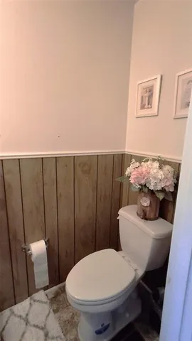 a bathroom with a toilet a sink and a mirror