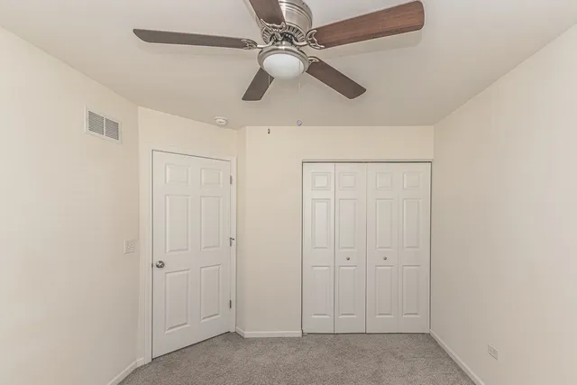 a white toilet sitting next to a white walls
