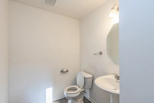 a view of a house with a large window and wooden fence