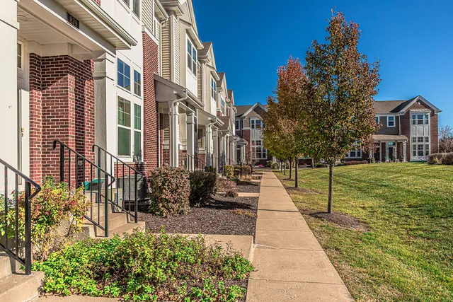 a pathway of a house with a yard