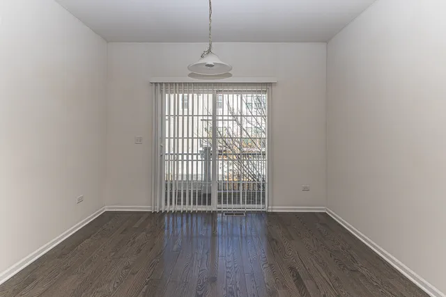 an empty room with a ceiling fan and a window