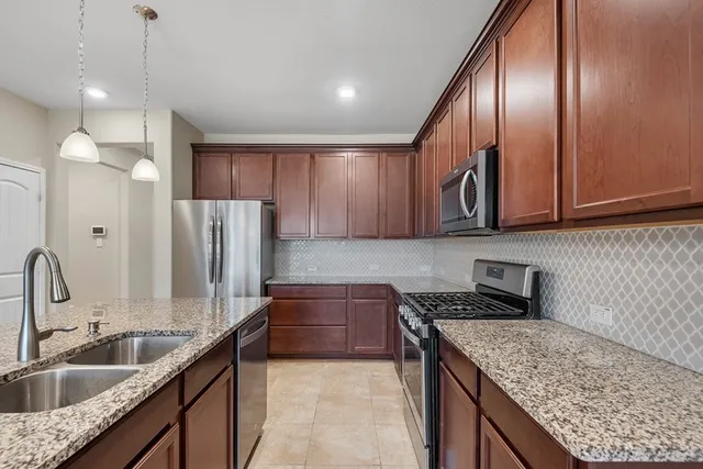 a kitchen with large cabinets a sink and dishwasher