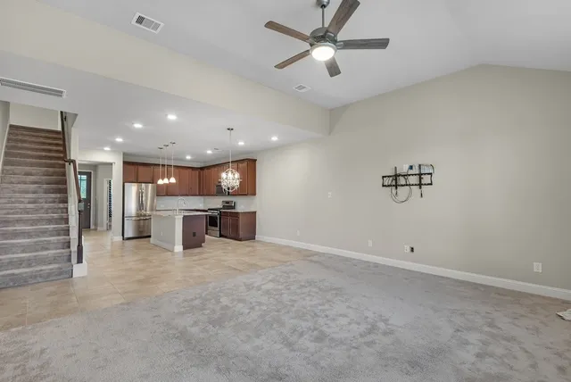 an empty room with a projector and a chandelier
