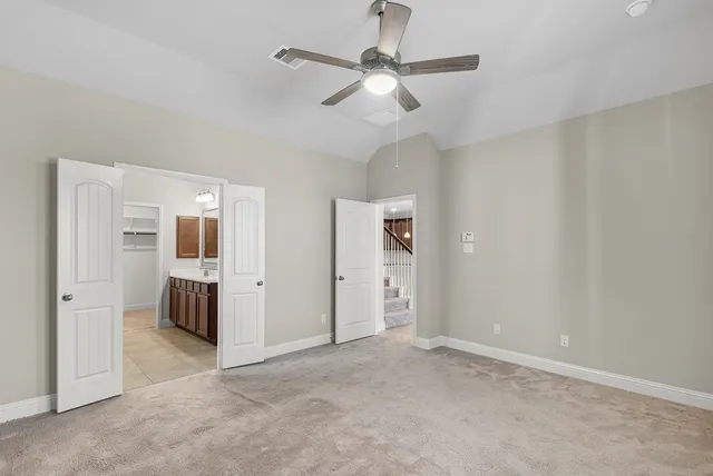 an empty room with closet and windows