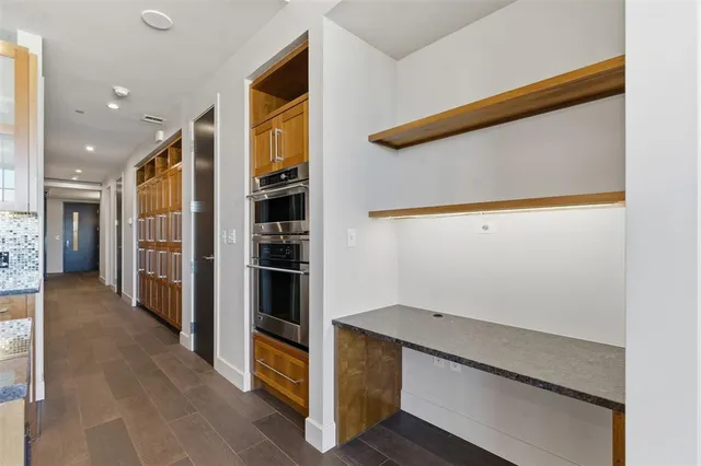 a view of hallway with stairs and wooden floor