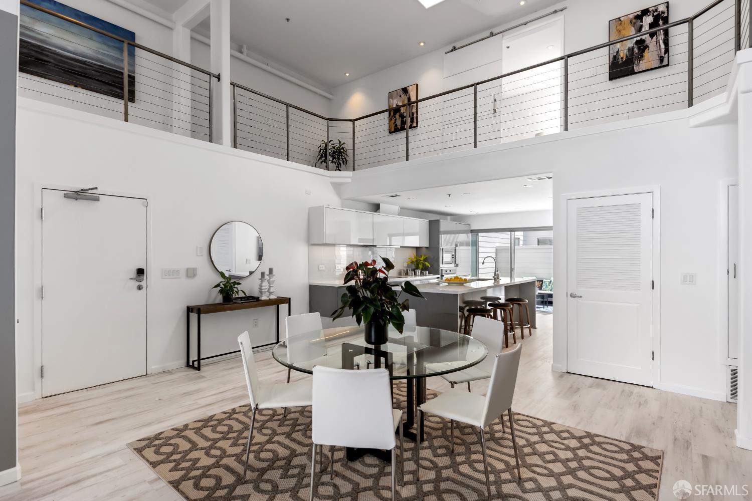 229 8th Street, Unit 3 San Francisco, CA 94103 - Photo 14 of 61 a dining room with wooden floor a chandelier a wooden table and chairs