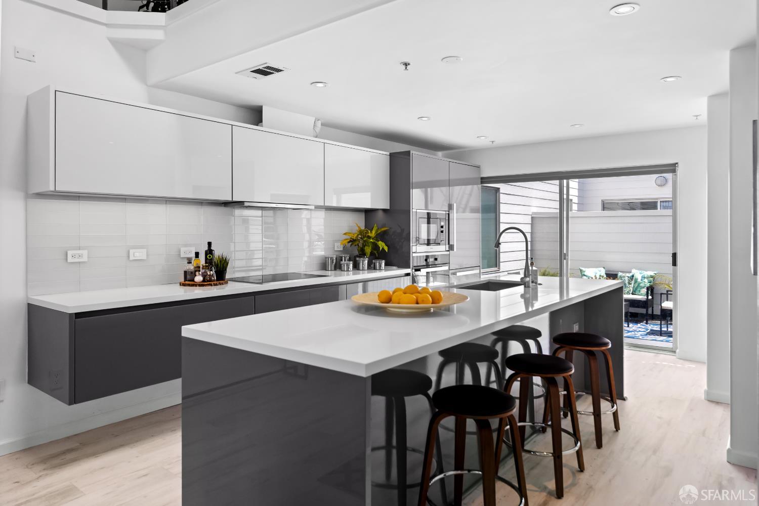 229 8th Street, Unit 3 San Francisco, CA 94103 - Photo 15 of 61 a kitchen with a table chairs sink and cabinets