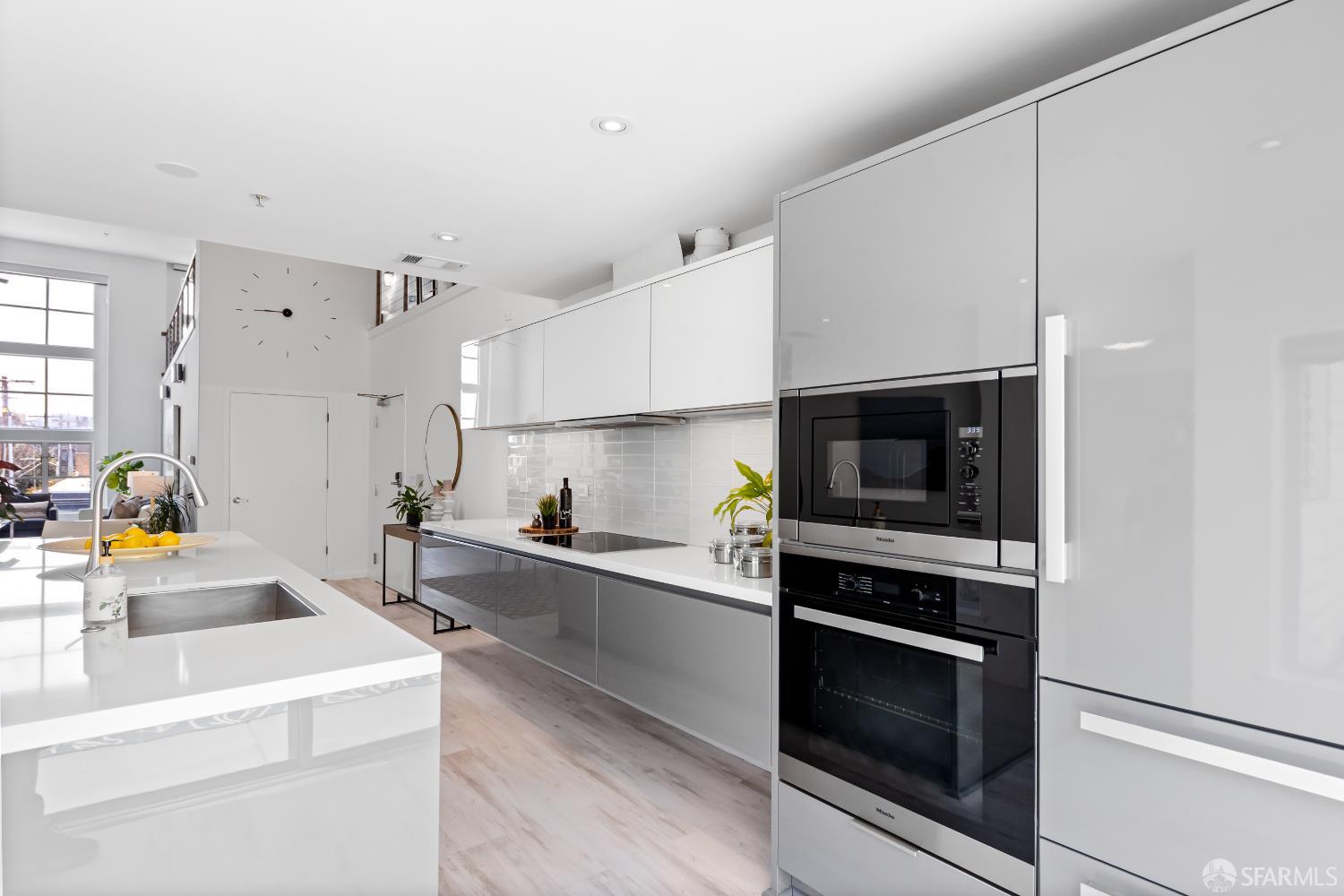 229 8th Street, Unit 3 San Francisco, CA 94103 - Photo 18 of 61 a kitchen that has a sink and a stove top oven