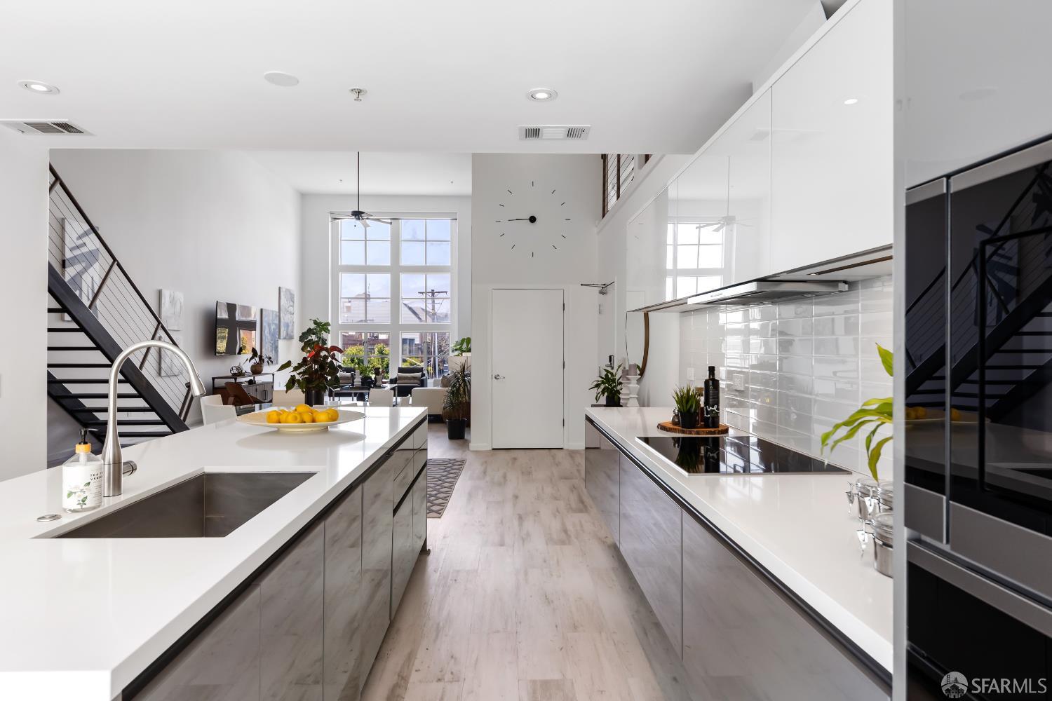 229 8th Street, Unit 3 San Francisco, CA 94103 - Photo 19 of 61 a kitchen with stainless steel appliances a sink a stove and white cabinets