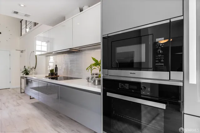 a bedroom with a bed and painting on the wall