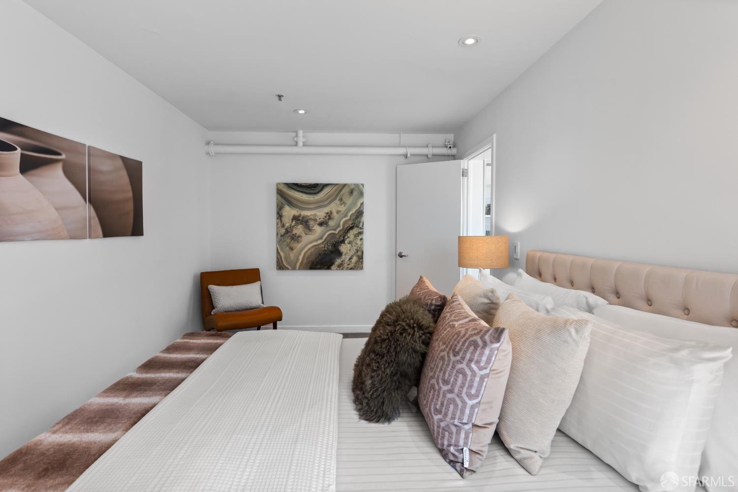 229 8th Street, Unit 3 San Francisco, CA 94103 - Photo 35 of 61 a bedroom with a bed and painting on the wall