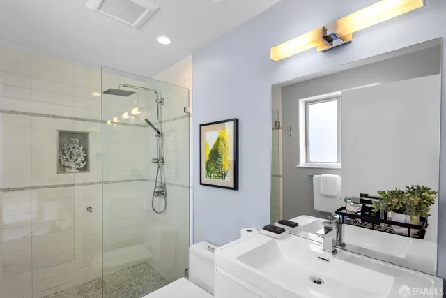 a bedroom with a bed a couch and a window