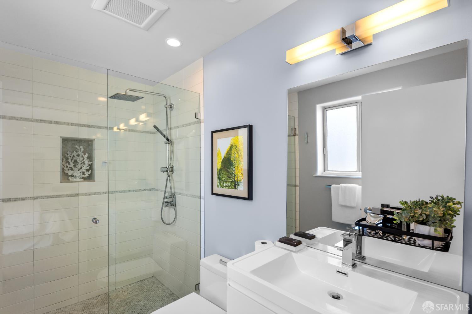 229 8th Street, Unit 3 San Francisco, CA 94103 - Photo 37 of 61 a bathroom with a sink a mirror and a shower