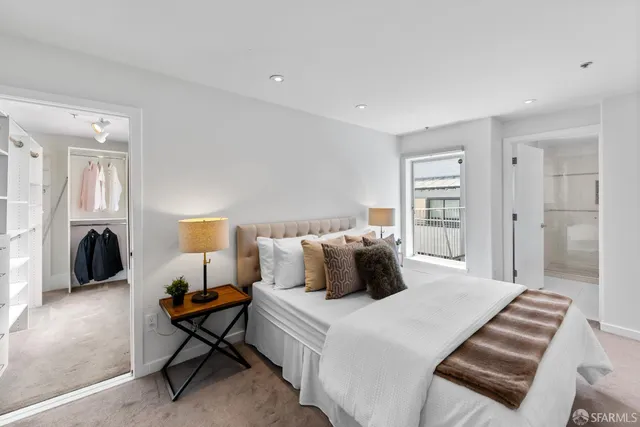a bed room with furniture and a flat screen tv
