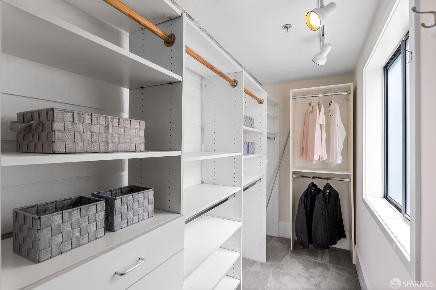 229 8th Street, Unit 3 San Francisco, CA 94103 - Photo 39 of 61 a view of walk in closet with clothes and shoes