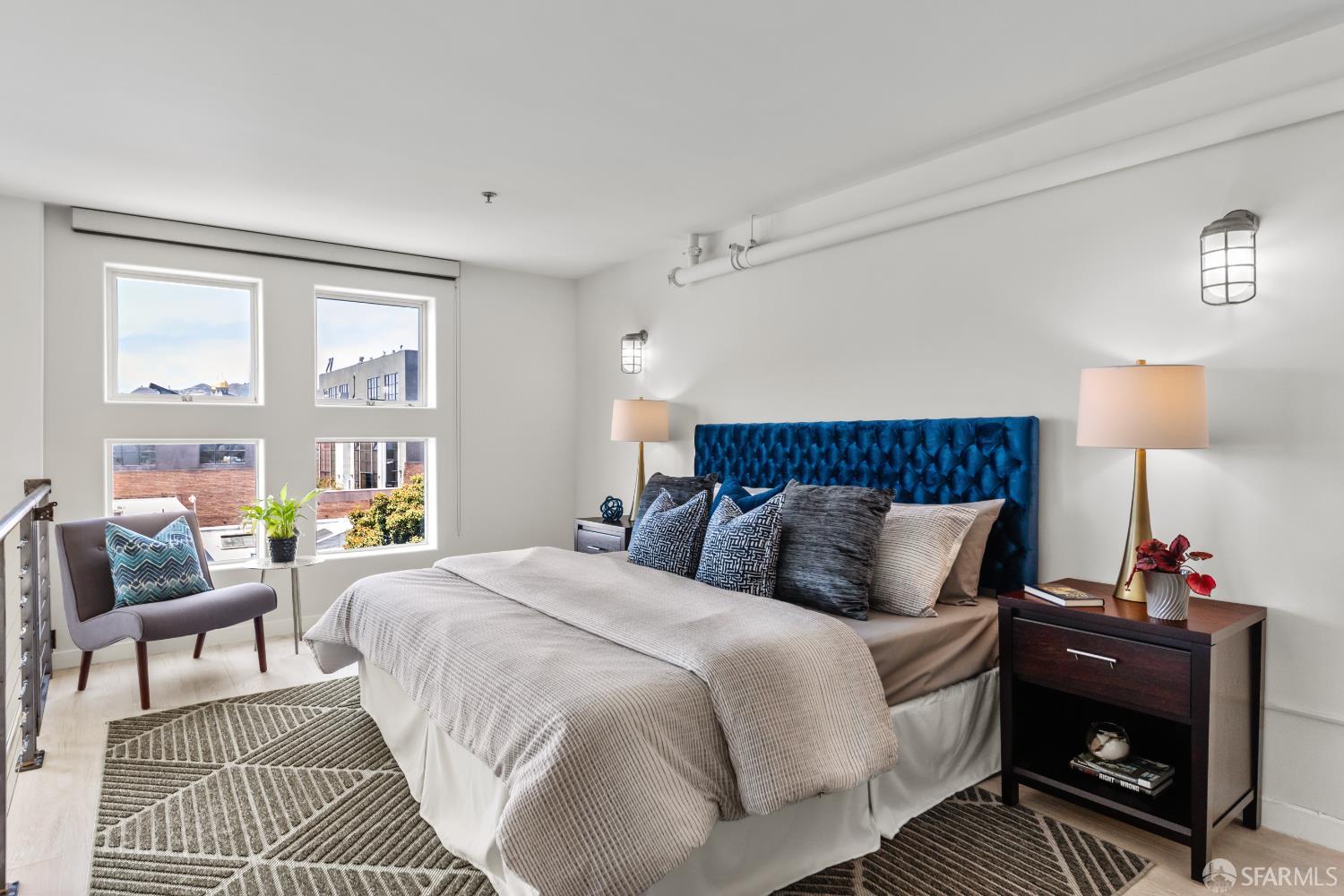 229 8th Street, Unit 3 San Francisco, CA 94103 - Photo 45 of 61 a bedroom with a bed a couch and a window