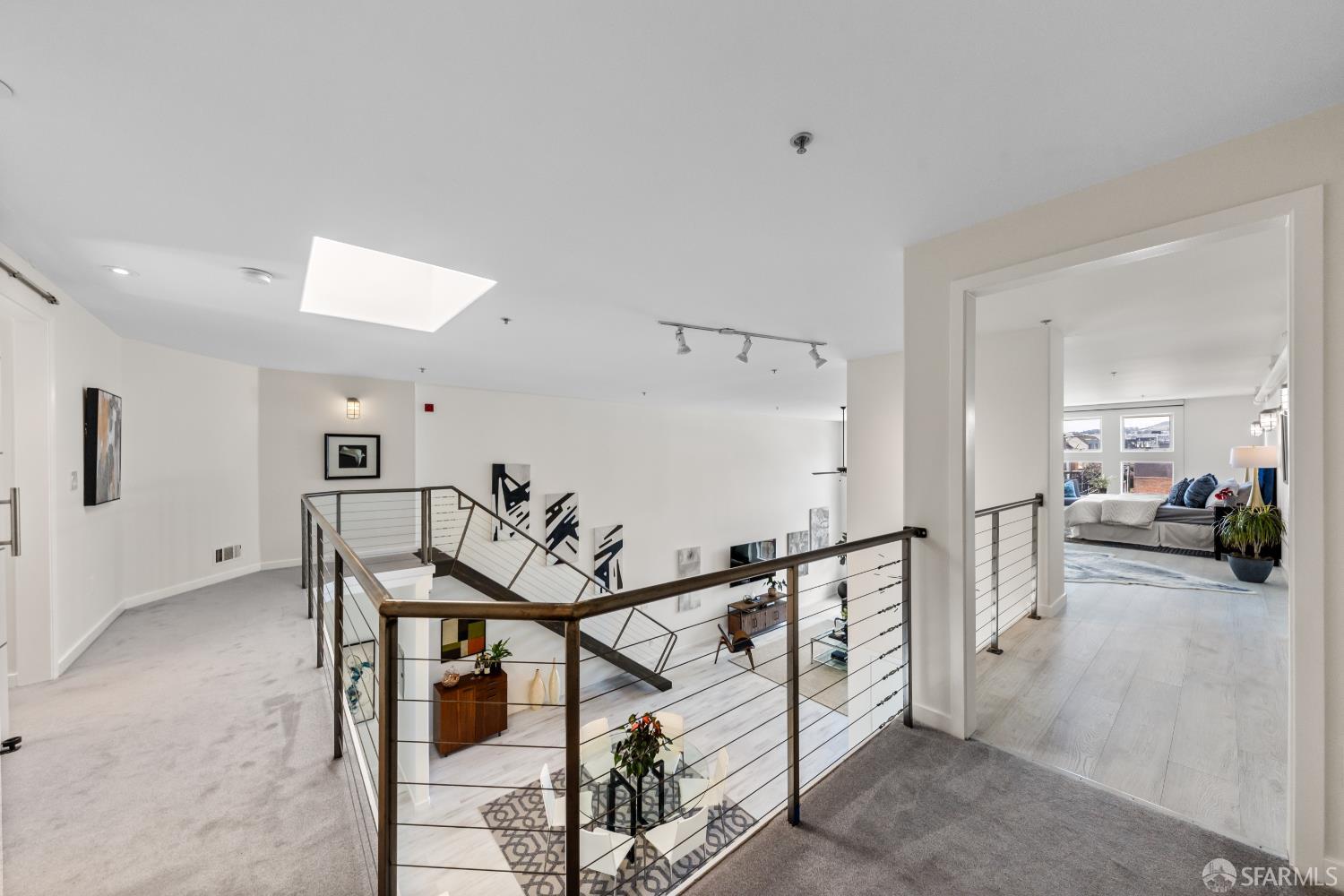 229 8th Street, Unit 3 San Francisco, CA 94103 - Photo 51 of 61 a view of a livingroom with furniture and a black and white kitchen