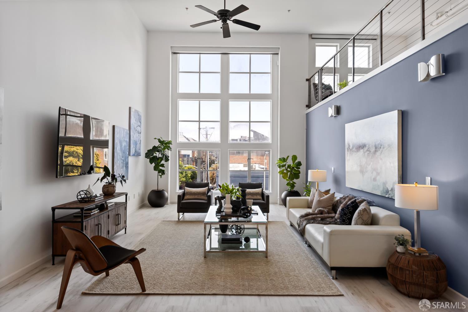 229 8th Street, Unit 3 San Francisco, CA 94103 - Photo 8 of 61 a living room with furniture and a flat screen tv