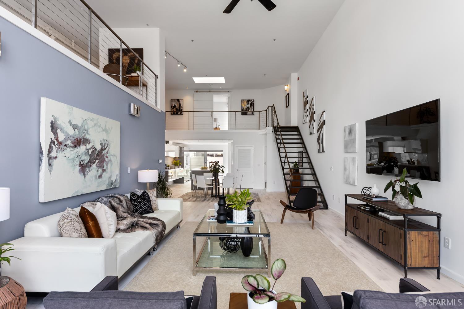 229 8th Street, Unit 3 San Francisco, CA 94103 - Photo 10 of 61 a living room with furniture and a flat screen tv