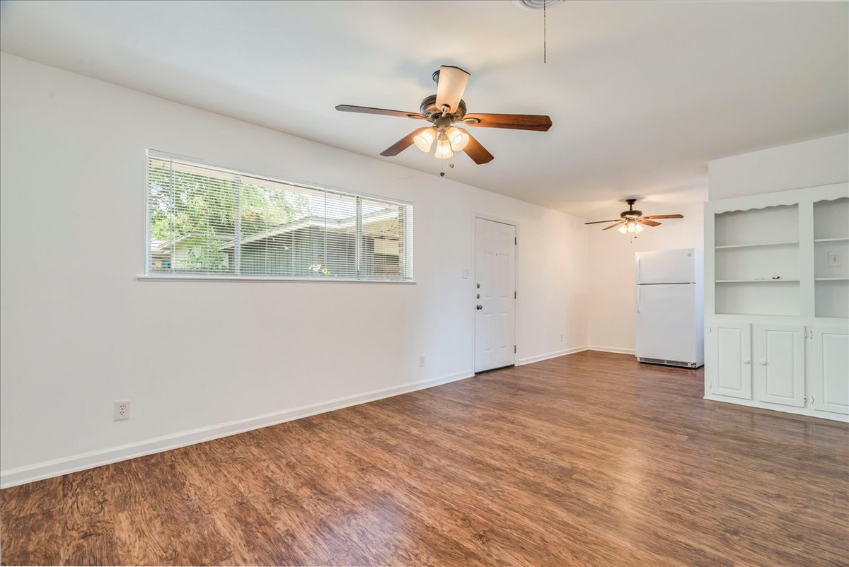 1417 Braes Ridge Drive, Unit B Austin, TX 78723 - Photo 7 of 22 wooden floor in an empty room with a window