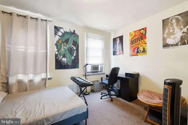 a bedroom that has a bed and a chair in it