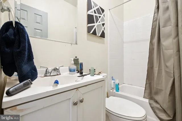 a bathroom with a sink toilet and mirror