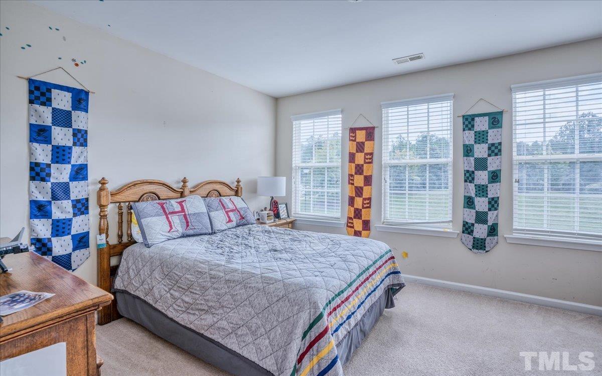 7604 Canvas Art Terrace Raleigh, NC 27617 - Photo 11 of 20 a bedroom with a bed and dresser