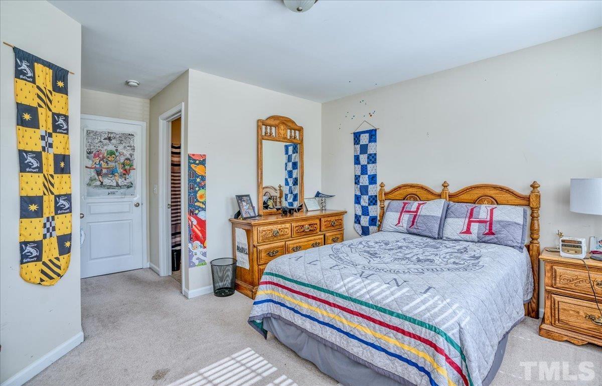 7604 Canvas Art Terrace Raleigh, NC 27617 - Photo 12 of 20 a bedroom with a bed and a table
