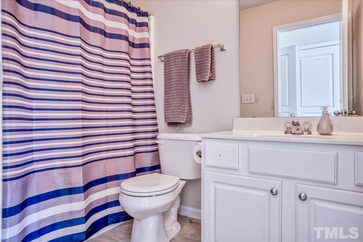 7604 Canvas Art Terrace Raleigh, NC 27617 - Photo 13 of 20 a bathroom with a sink mirror vanity and toilet