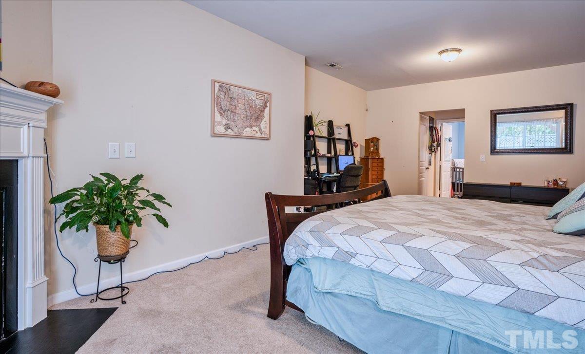 7604 Canvas Art Terrace Raleigh, NC 27617 - Photo 14 of 20 a bedroom with a bed and a potted plant